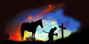 Cowboy kneeling at cross, with his horse